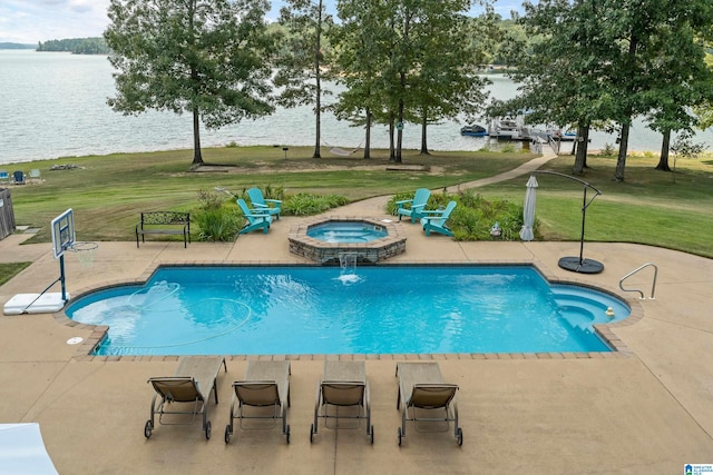 view of swimming pool featuring an in ground hot tub, a patio area, a water view, and a lawn