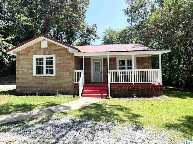 view of front of property with a front yard and covered porch