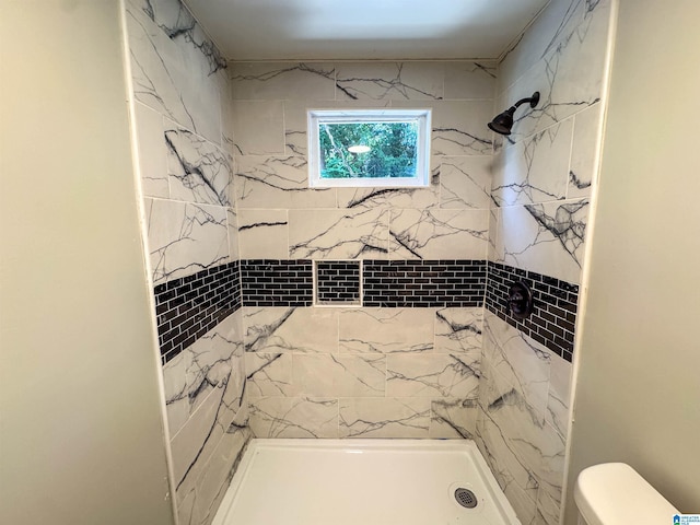 bathroom featuring a shower stall and toilet