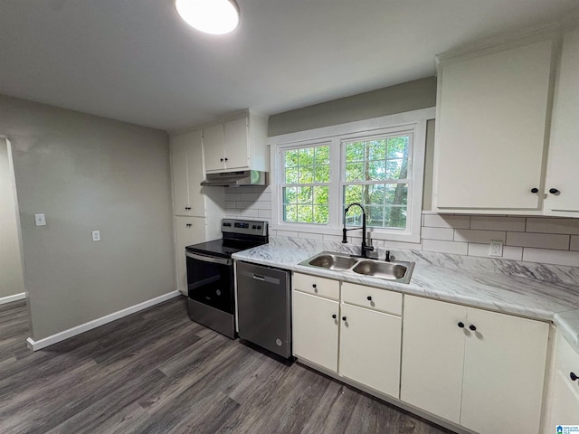 kitchen with appliances with stainless steel finishes, backsplash, dark hardwood / wood-style flooring, and sink