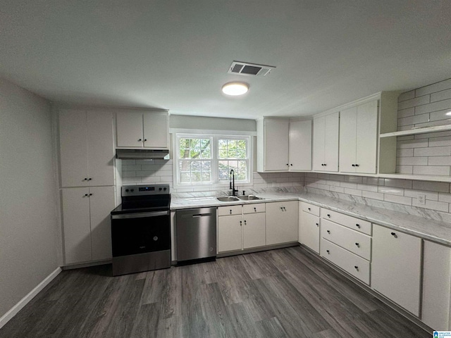 kitchen with tasteful backsplash, stainless steel appliances, sink, dark hardwood / wood-style floors, and white cabinets