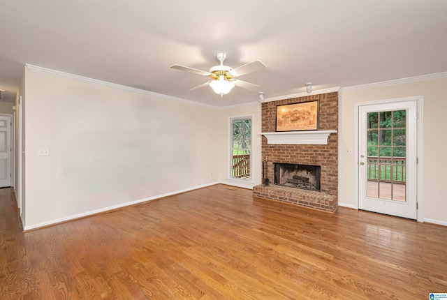 unfurnished living room with a healthy amount of sunlight, ceiling fan, hardwood / wood-style flooring, and a fireplace