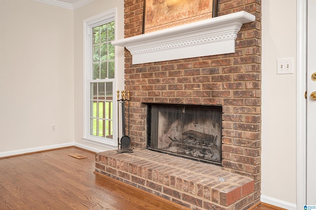 room details featuring hardwood / wood-style flooring, a fireplace, and ornamental molding