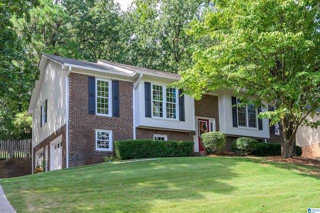 bi-level home with a garage and a front lawn