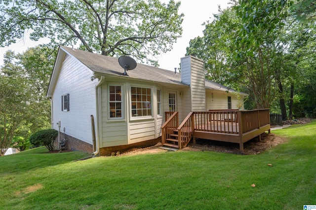 rear view of property featuring a lawn and a wooden deck