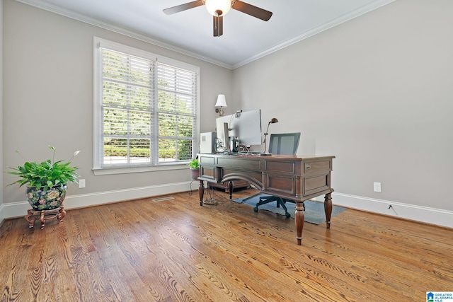 office space featuring ornamental molding, ceiling fan, baseboards, and wood finished floors