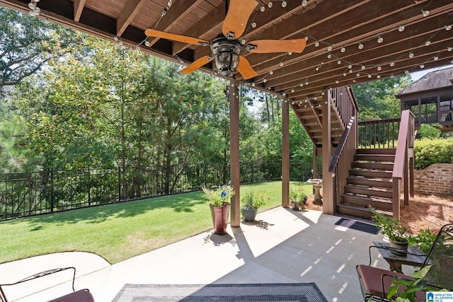 view of patio / terrace featuring a ceiling fan, a fenced backyard, and stairs