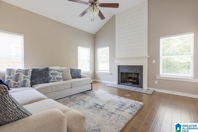 living room featuring ceiling fan, high vaulted ceiling, and wood-type flooring