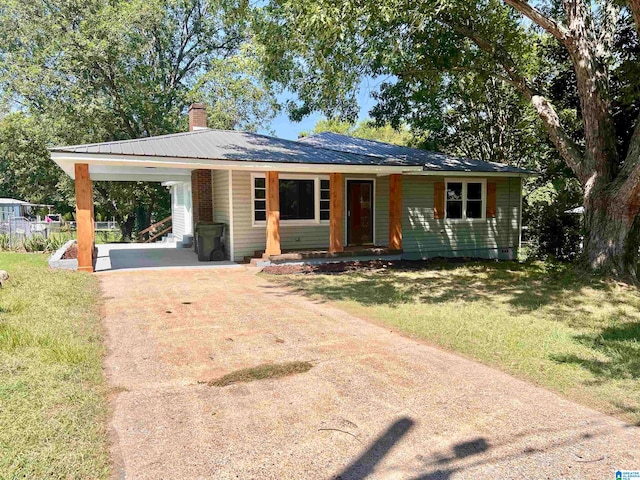 ranch-style house featuring a carport and a front yard