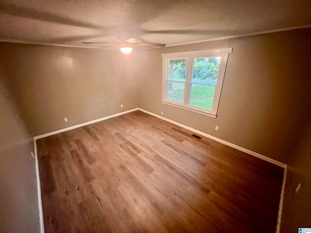 unfurnished room with ceiling fan and hardwood / wood-style floors