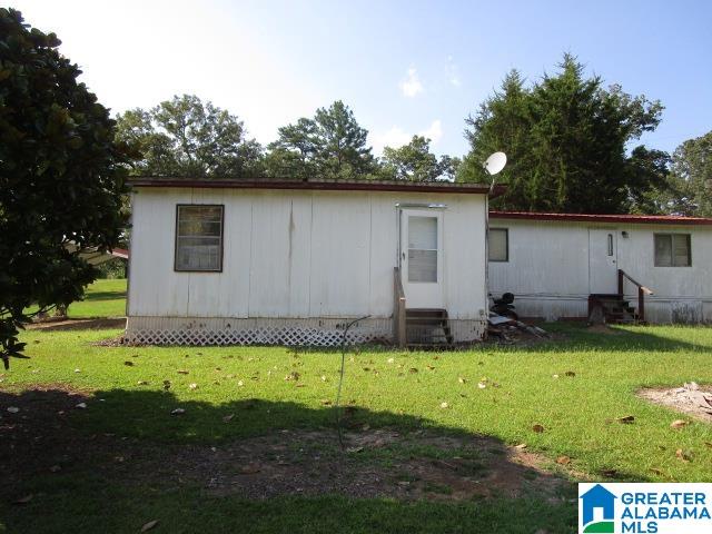 back of property featuring a lawn