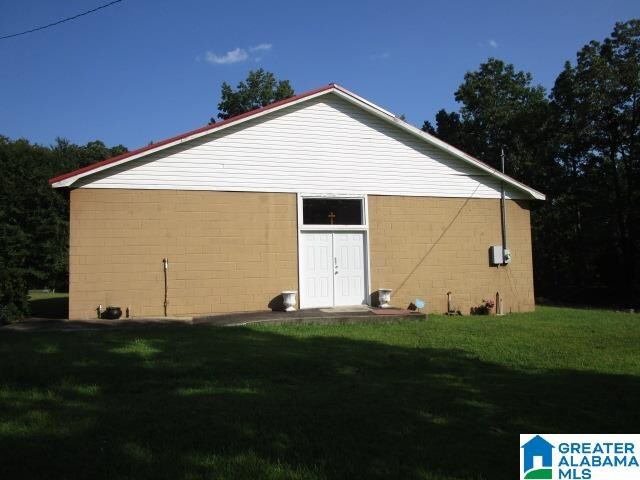 view of side of home with a lawn