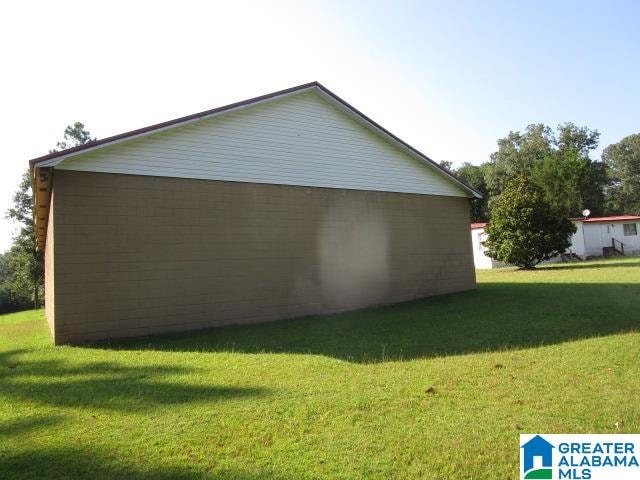 view of side of property with a yard