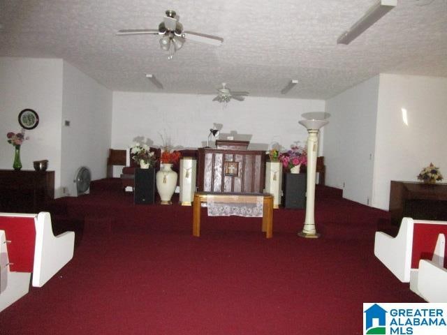 interior space with ceiling fan and a textured ceiling