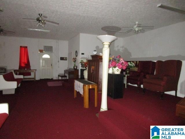 carpeted living room with a textured ceiling and ceiling fan