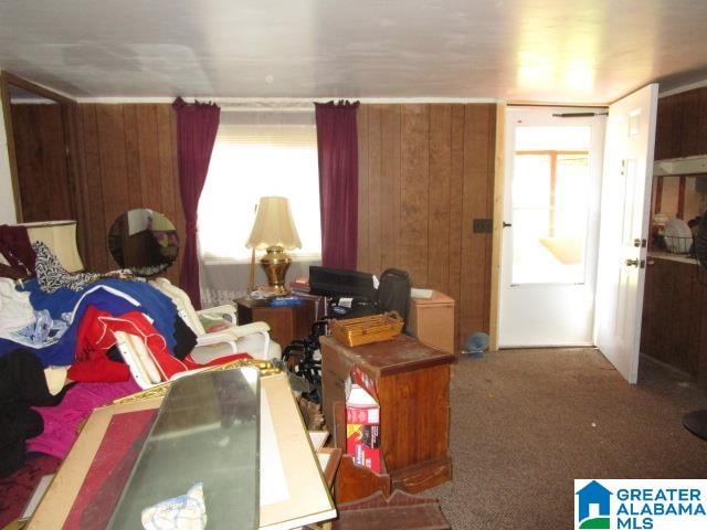 living room with carpet and wood walls