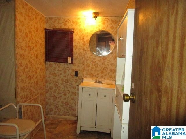 bathroom featuring vanity and toilet