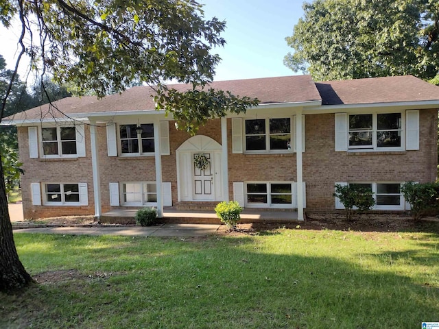 raised ranch with a front yard