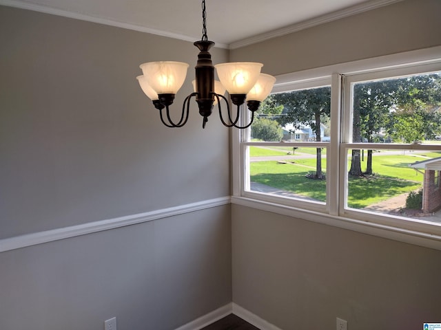 unfurnished dining area featuring an inviting chandelier and ornamental molding