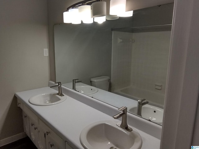 full bathroom featuring toilet, tiled shower / bath combo, and vanity