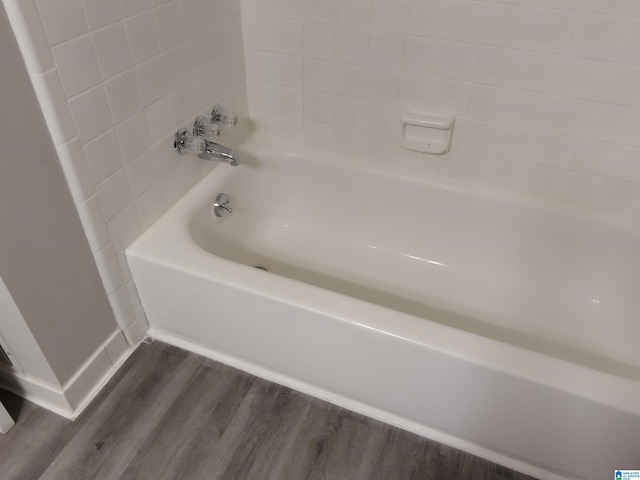 bathroom featuring a washtub and hardwood / wood-style flooring