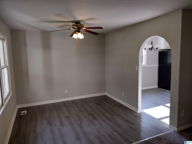 unfurnished room with hardwood / wood-style floors and ceiling fan with notable chandelier