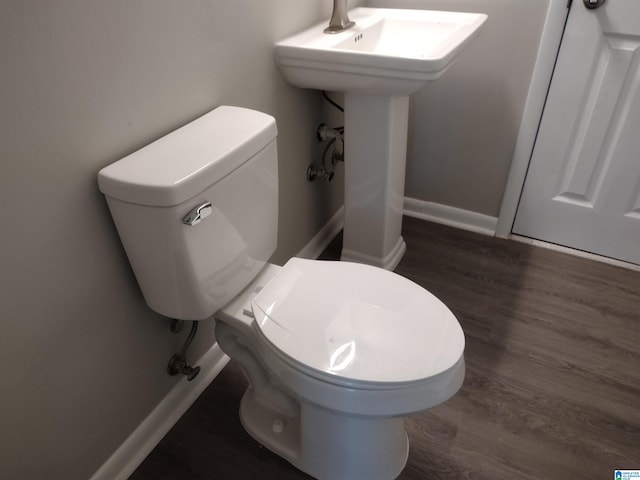 bathroom with hardwood / wood-style floors and toilet