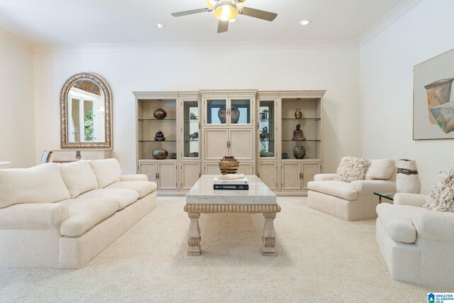 living room featuring light colored carpet, ornamental molding, and ceiling fan