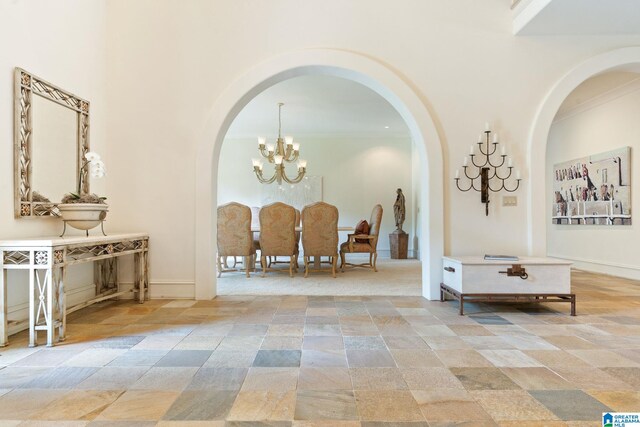 interior space with light tile patterned floors and an inviting chandelier