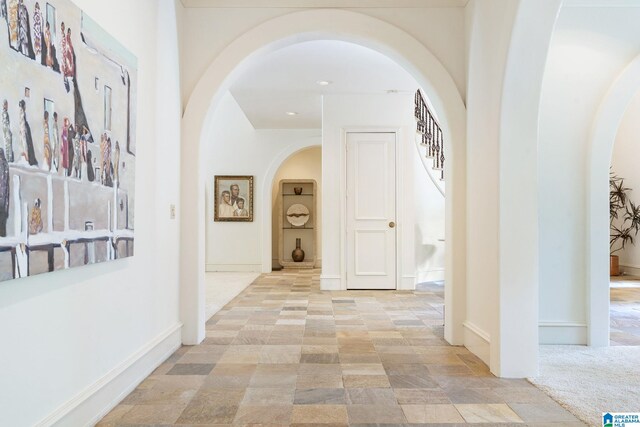 corridor with light tile patterned flooring