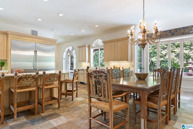 tiled dining space featuring a notable chandelier and crown molding