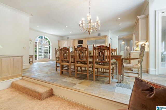 tiled dining space featuring an inviting chandelier and ornamental molding