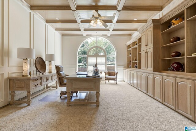 carpeted home office featuring ceiling fan, beamed ceiling, and coffered ceiling