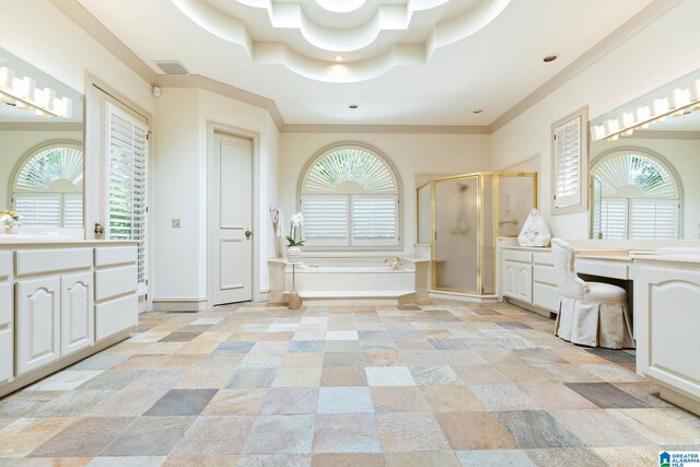 bathroom featuring tile patterned flooring, separate shower and tub, vanity, and a raised ceiling