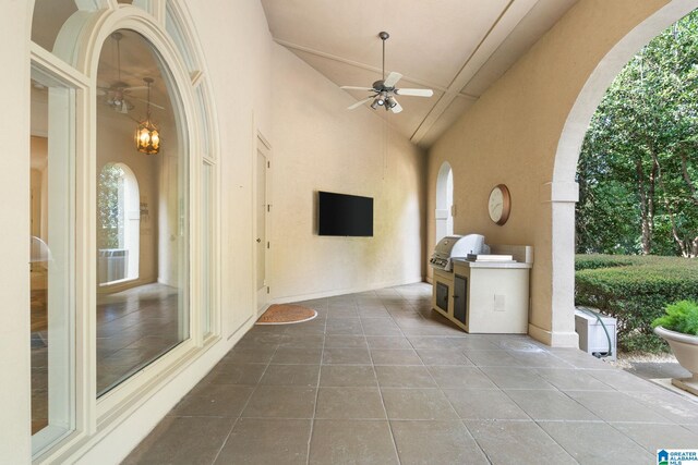 view of patio featuring ceiling fan, grilling area, and exterior kitchen