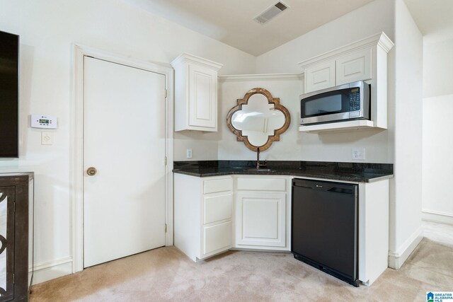 kitchen with dishwasher, white cabinetry, stainless steel microwave, and light colored carpet