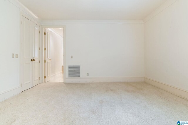 carpeted empty room with ornamental molding