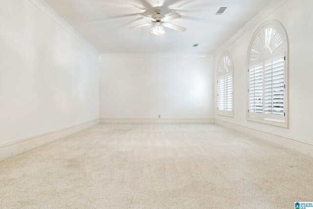 unfurnished room with ceiling fan, ornamental molding, and light colored carpet