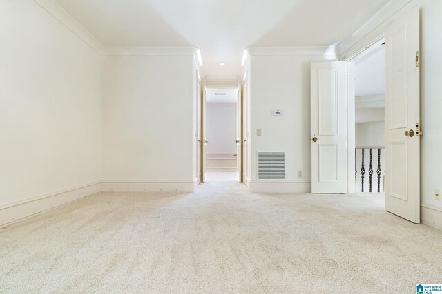 carpeted empty room with crown molding