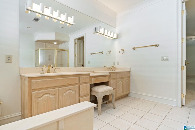 bathroom featuring tile patterned flooring, ornamental molding, a shower with shower door, and vanity