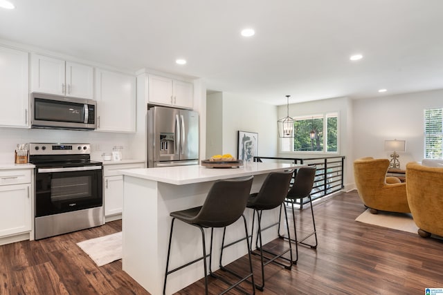 kitchen with white cabinetry, dark hardwood / wood-style flooring, plenty of natural light, and stainless steel appliances