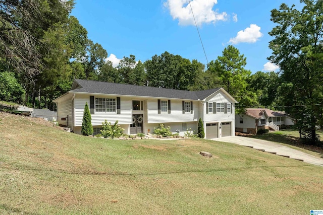 split foyer home with a garage and a front yard