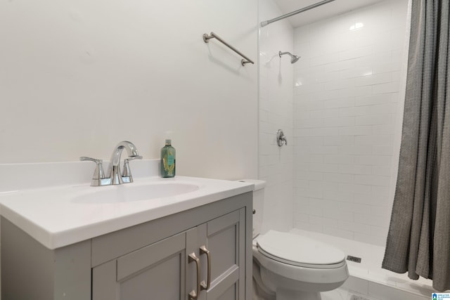 bathroom with walk in shower, toilet, and vanity