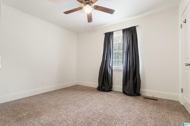 spare room with light colored carpet and ceiling fan