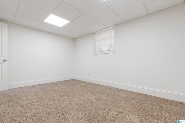 basement with carpet flooring and a drop ceiling