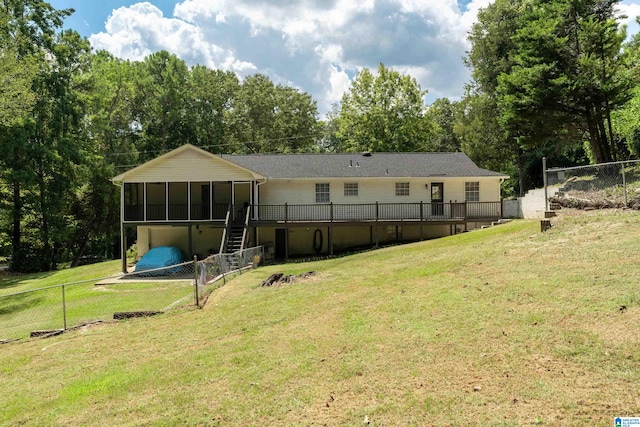 back of house featuring a yard and a sunroom