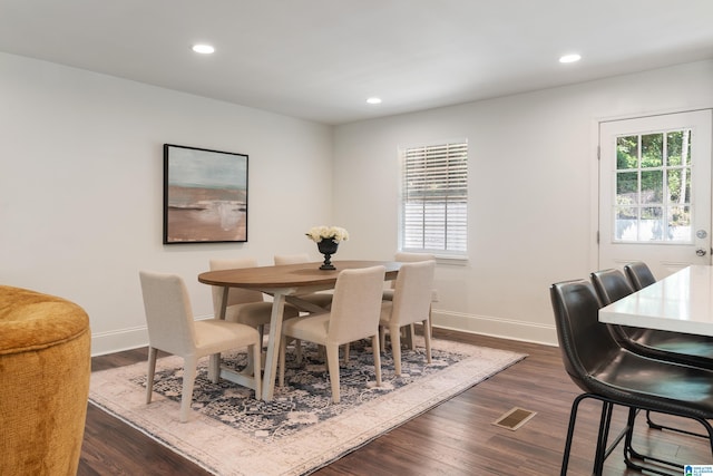 dining area with dark hardwood / wood-style flooring