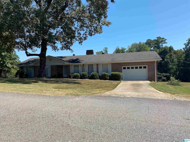 ranch-style home with a garage and a front yard