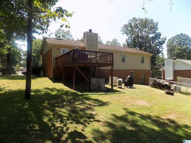 back of property featuring a lawn, a chimney, stairs, a wooden deck, and brick siding