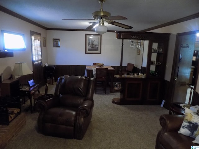 living area featuring ornamental molding, carpet, and ceiling fan